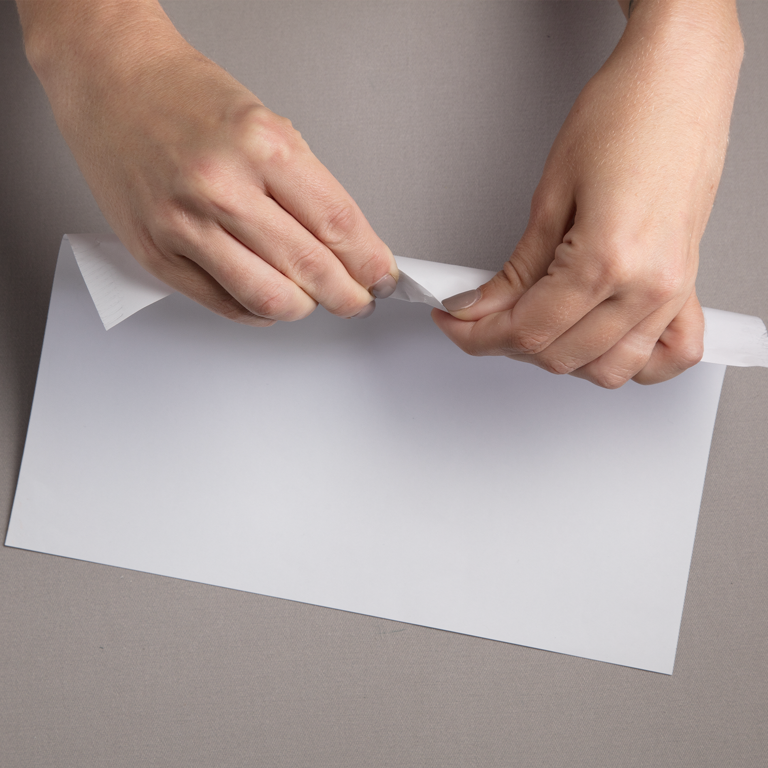 person trying to tear water and tear resistant paper